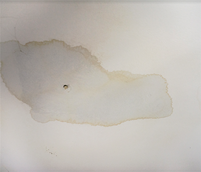 a water damaged white wall with water marks on it