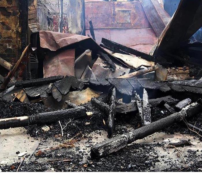 burned home; fire damaged debris