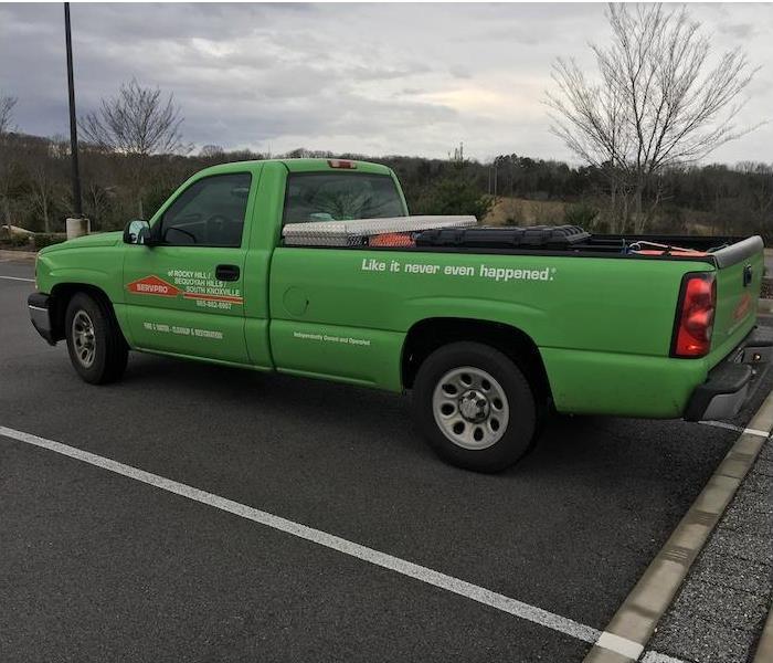 Green SERVPRO truck in a parking lot