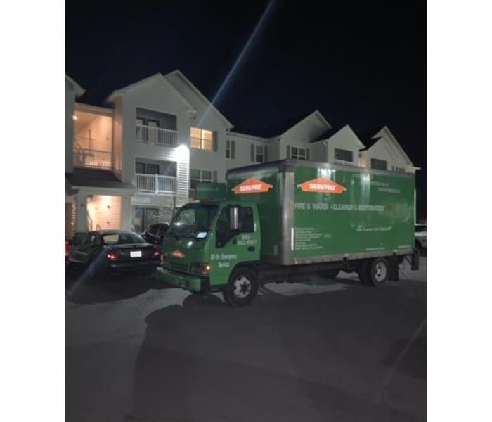 a SERVPRO truck in the parking lot of an apartment complex