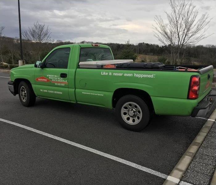 Green SERVPRO truck in a parking lot